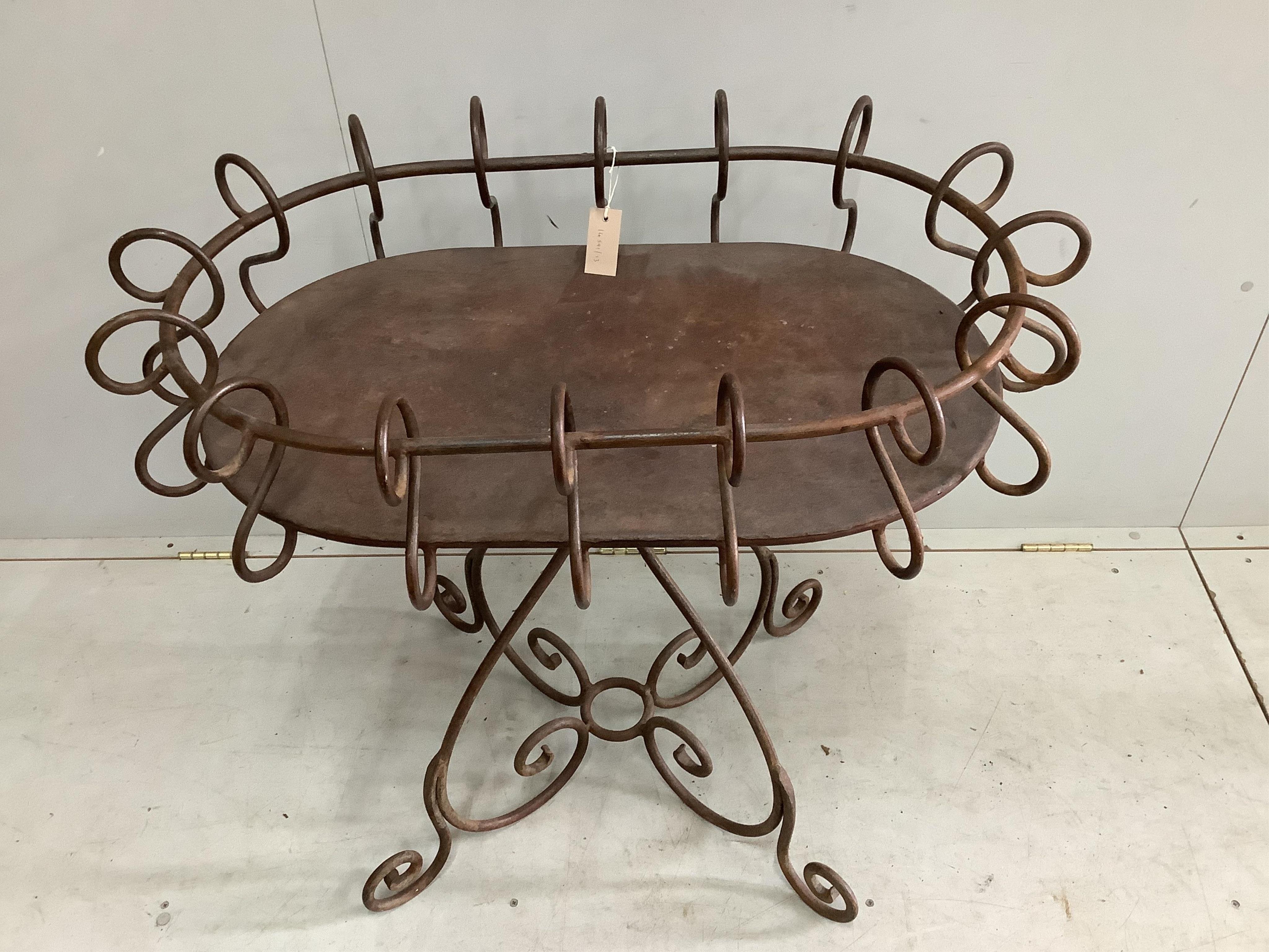A wrought iron oval centre table, width 88cm, depth 60cm, height 82cm. Condition - fair to good